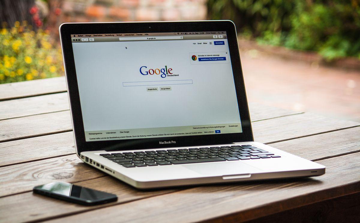 Laptop displaying a Google search, comparing SEO and PPC visibility